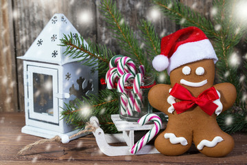 Christmas card with gingerbread man in hat and candy canes