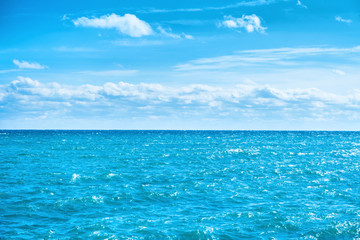 Sea water and blue sky with white clouds