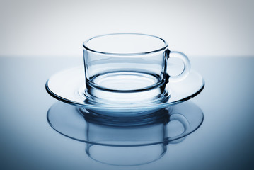 Glass coffee tea cup on a blue background