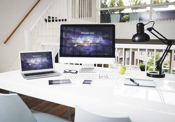 Laptop and Desktop Computer at an Office Desk Mockup 1