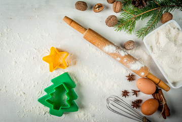 Making traditional christmas gingerbread cookies. Christmas-tree branches, a rolling pin, whisk for whipping eggs, nuts and cones they lie on a table nearby