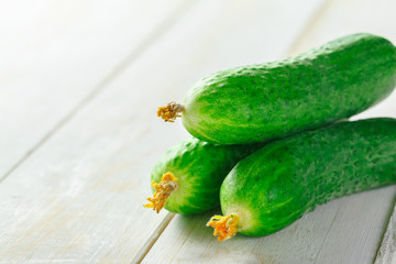  cucumbers on wooden background