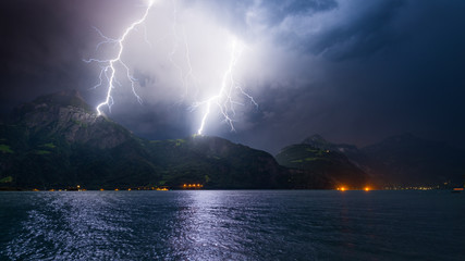 Thunderstorm  with Lightning. Mountain landscape by storm and rain. Discharge of lightning strikes the top of the mountains.