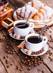 Breakfast with coffee and croissants on table