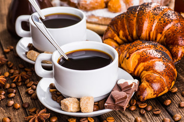 Breakfast with coffee and croissants on table