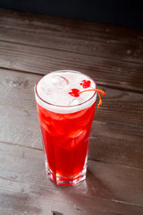 Rose coctail with ice on black background