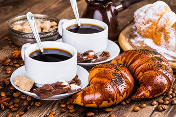 Breakfast with coffee and croissants on table