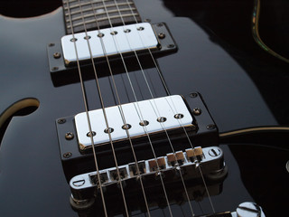 black electric guitar close up detail