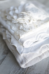 pile of white plaids on a wooden table