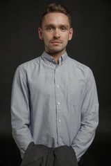 Obraz premium Portrait of young businessman on dark background