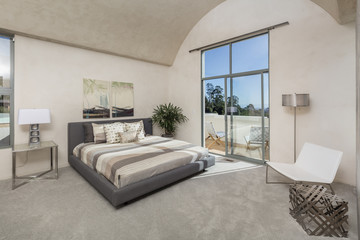 Modern luxurious bedroom with a balcony.