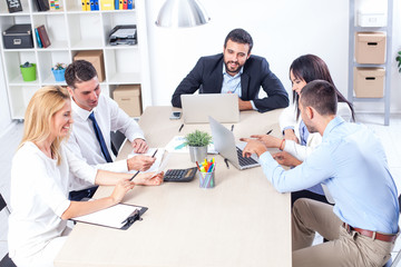 Fototapeta premium Group Of Business People Having Meeting In Office. Business partners discussing documents and ideas at meeting