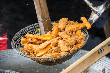 Sweetened fried banana fritters in hot oil, Thailand dessert