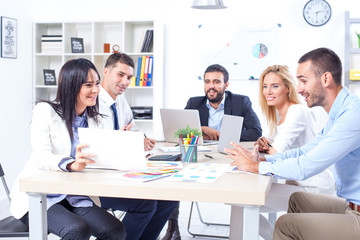 Fototapeta premium Group Of Business People Having Meeting In Office. Business partners discussing documents and ideas at meeting