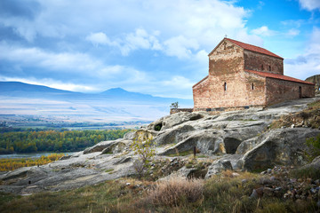 Fototapeta na wymiar Uplistsikhe. Rock cave city with christian basilica church in Georgia