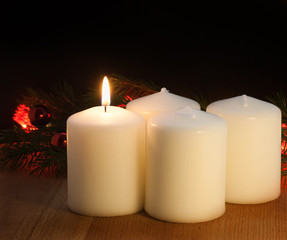 Christmas candles and lights. First Sunday of the Advent. Prophecy Candle on a dark background.