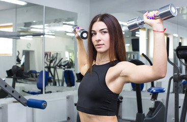 Fototapeta premium Girl is engaged in sports and gymnastics in the gym