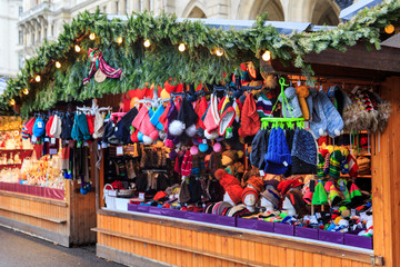 Fototapeta na wymiar Street kiosk on a christmas fair market selling winter hats