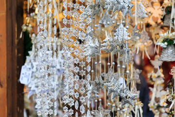 Colorful close up details of christmas fair market. Stars balls decorations for sales.