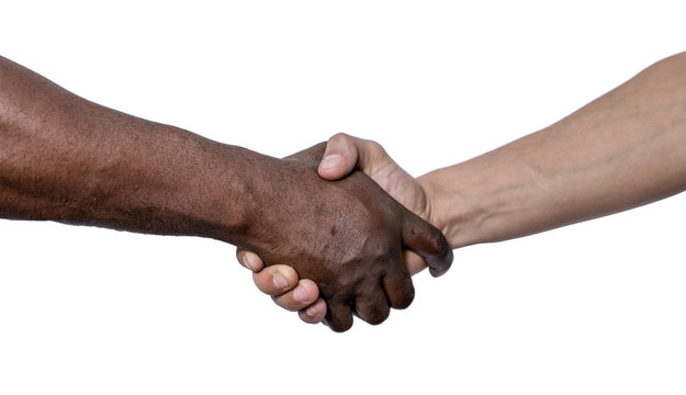 Shaking hands as a sign of friendship, hand in white and black