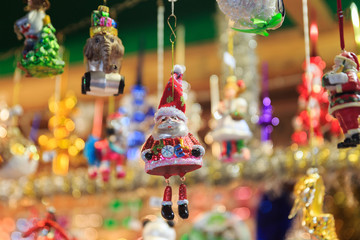 Colorful close up details of christmas fair market. Santa Claus and a telephone booth balls decorations in a box for sales.