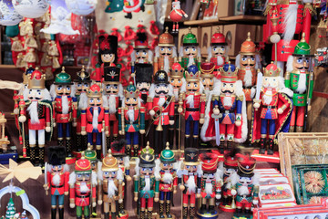 Colorful close up details of christmas fair market. Nutcracker figures decorations for sales.