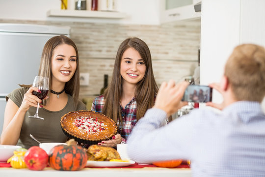 Three Freinds Eating Pie In Kitchen And Taking A Photos