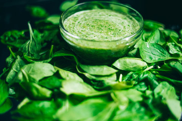 Fresh green juice smoothie made with organic green fruits and vegetables. The texture of the leaves. The concept of a healthy lifestyle