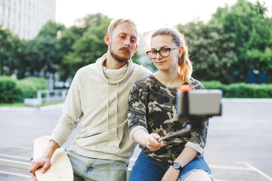Couple with longboards doing selfie