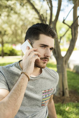 Portrait of handsome young man talking on the phone