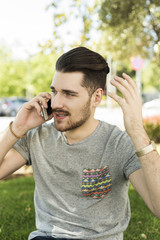 Portrait of handsome young man talking on the phone