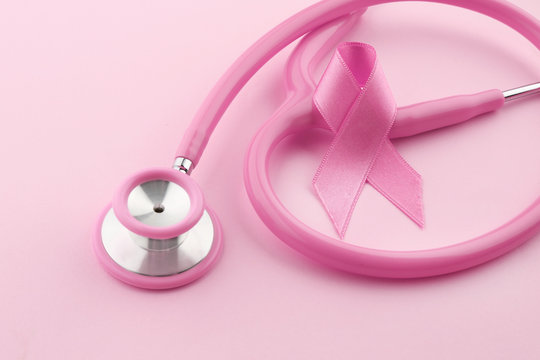 Stethoscope with pink ribbon on color background. Breast cancer concept