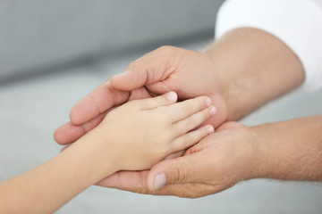 Old and young hands, closeup