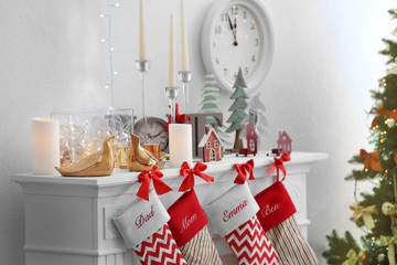 Christmas socks hanging on fireplace in room interior