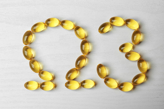Fish oil pills in omega3 shape on light background