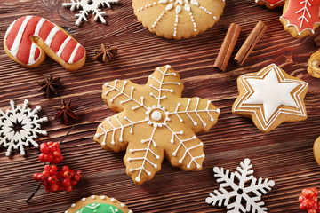 Tasty Christmas cookies and decor on wooden table, close up view