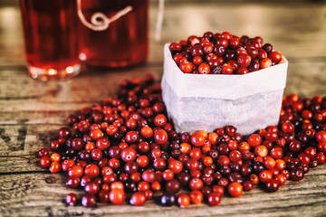 Heap of fresh Cranberries on vintage wooden background. Cranberry juice. Healthy food.