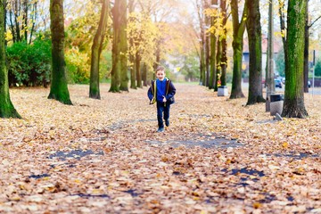 Happy little boy running