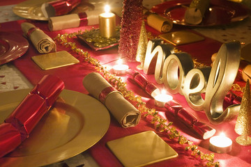 Table decorated red and gold for Christmas day dinner