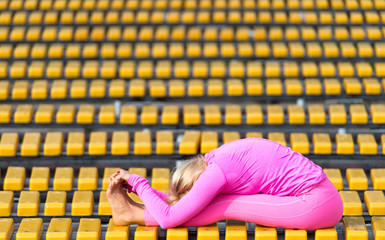 Preatty young woman doing yoga asanas in the park