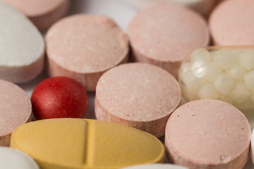 Multiple pills depicting medical treatment or pahrmaceutical ind