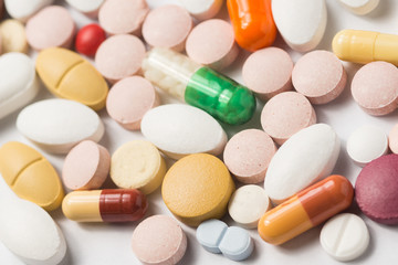 Multiple pills depicting medical treatment or pahrmaceutical ind