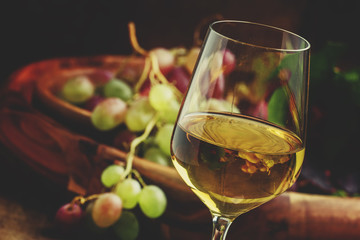 Autumn ice wine, ripe grapes and dried leaves, vintage wooden ba