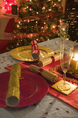 Table decorated red and gold for Christmas day dinner