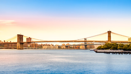 Brooklyn Bridge and Manhattan skyline at sunset viewed from Pier2 park in New Yok City
