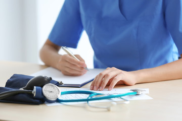 Stethoscope and blood pressure meter on doctor's table