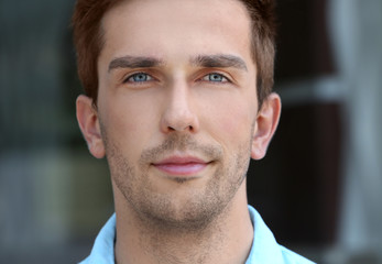 Fototapeta premium Young handsome businessman on blurred background