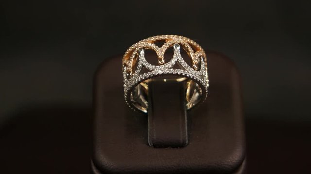 jewelry, Jewelry gold ring inlaid with glittering jewels, gold ring, jewelery sold in the jewelry store, the mall, the ring is in storefront one ring consisting of two parts, the white and yellow gold