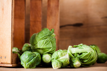 Ripe fresh brussels sprouts on wood board. 