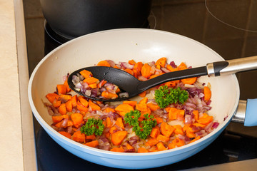 Cut the onions and carrots cooking in a pan